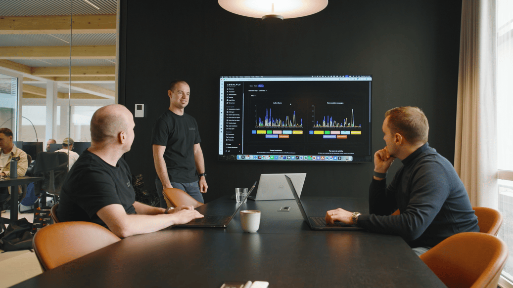 Legalfly & Zure Resident Azure Expert, two people sitting in a conference room looking at a person showing figures from a screen