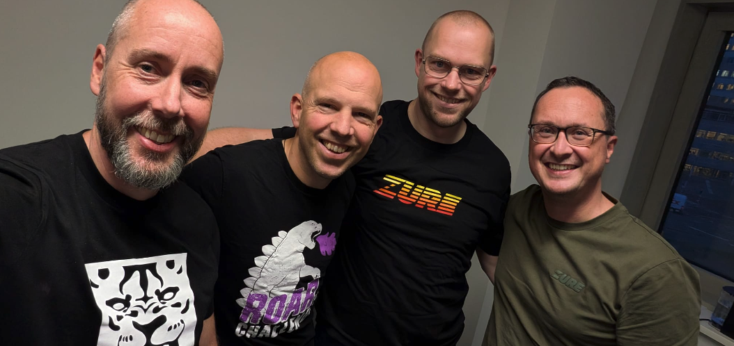 Team Zure Netherlands, four people taking a group selfie with Zure shirts on.