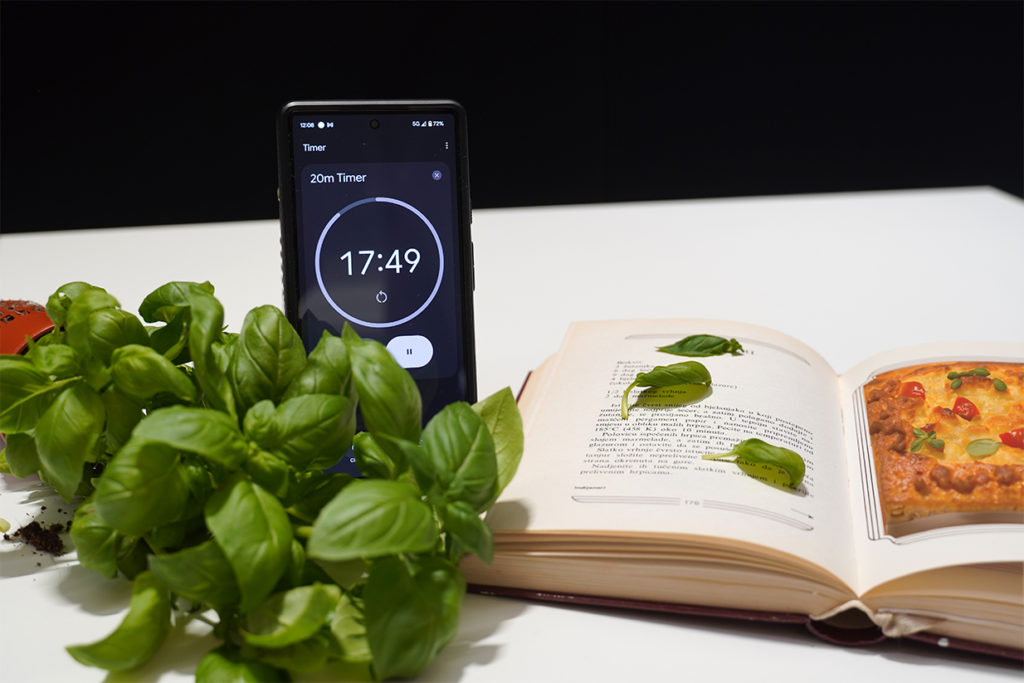 Phone timer running down with a cook book open next to it representing time, effort and goal.